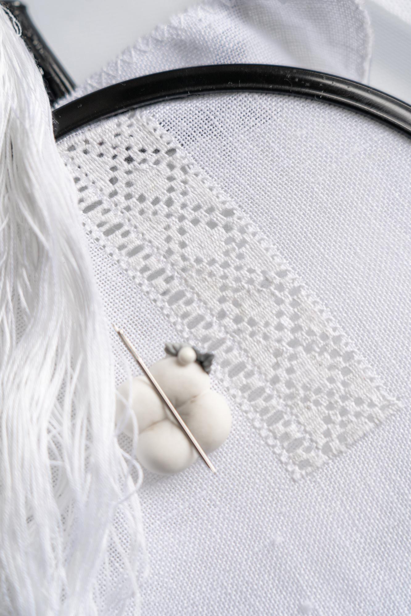 Close-up of contemporary white embroidery on linen